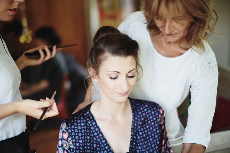 bride having make up done for her Ratsbury Barn Wedding