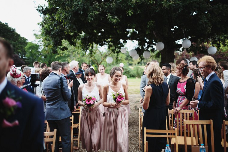 Bridesmaids walking down aisle at Ratsbury Barn Wedding
