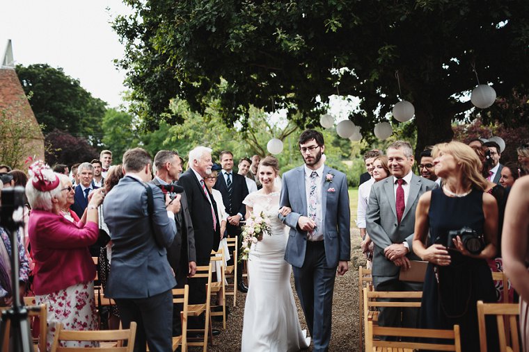 Bride walking down aisle at Ratsbury Barn