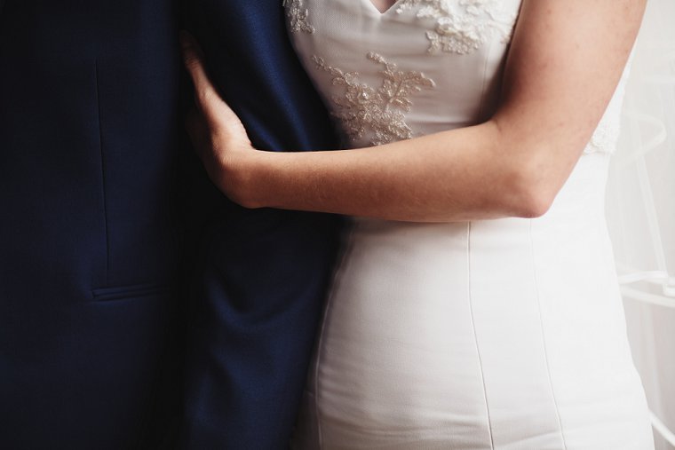 Bride holding groom's arm
