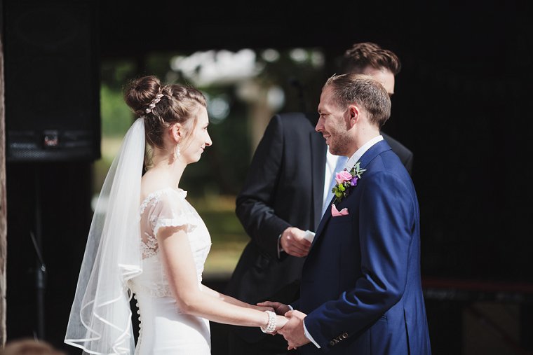 Bride and Groom facing eachother holding hands
