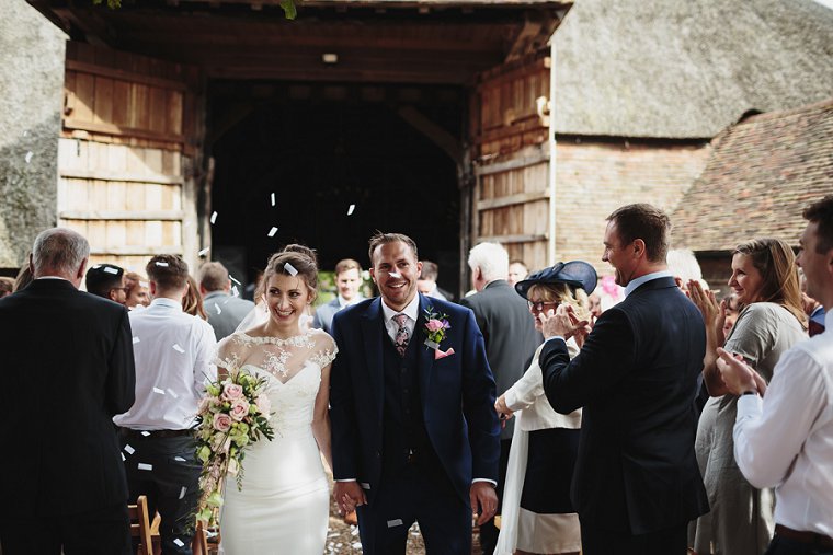 Bride and Groom walking down the aisle at Ratsbury Barn