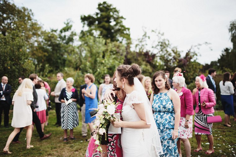 Bride hugging wedding guest at Ratsbury Barn Wedding