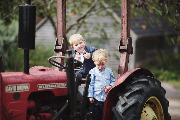 two children sat on tractor at wedding