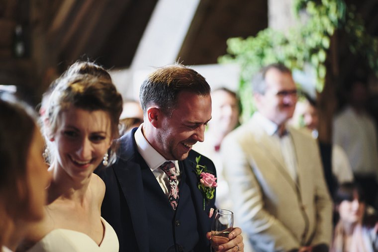 Groom laughing during best mans speech
