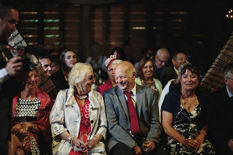 Wedding guests laughing during best man speeches