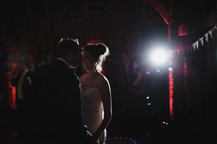 Bride smiling at groom during their first danceat Ratsbury Barn wedding