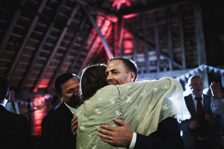 Groom hugging wedding guest