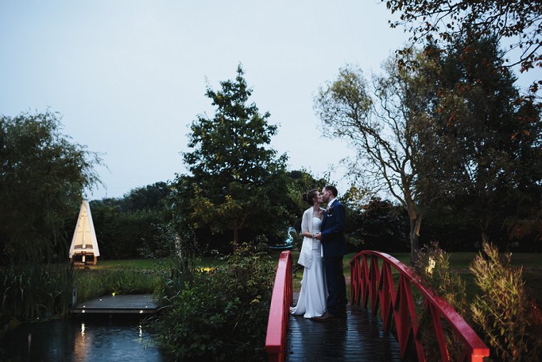 Bride and groom on bridge at Ratsbury Barn Wedding