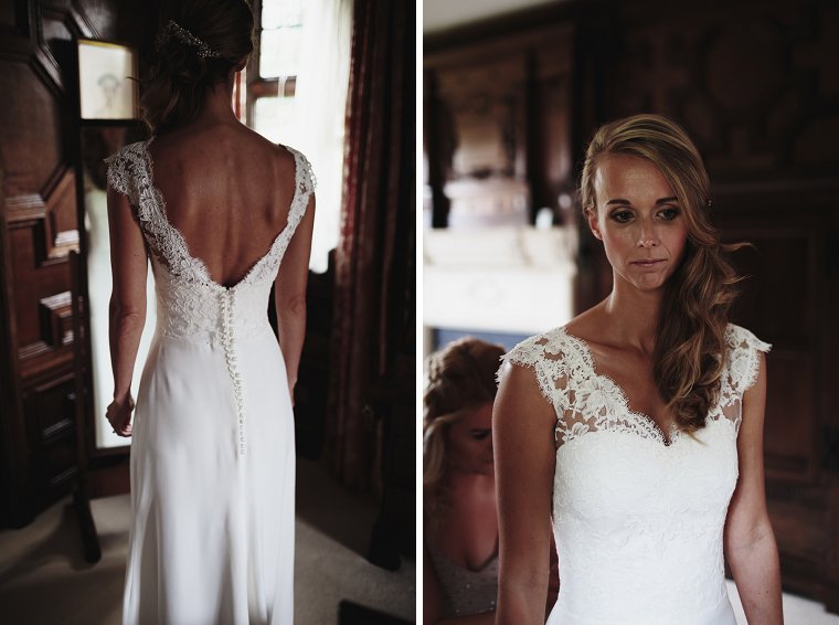 Bride having her dress arranged by her bridesmaid before her wedding