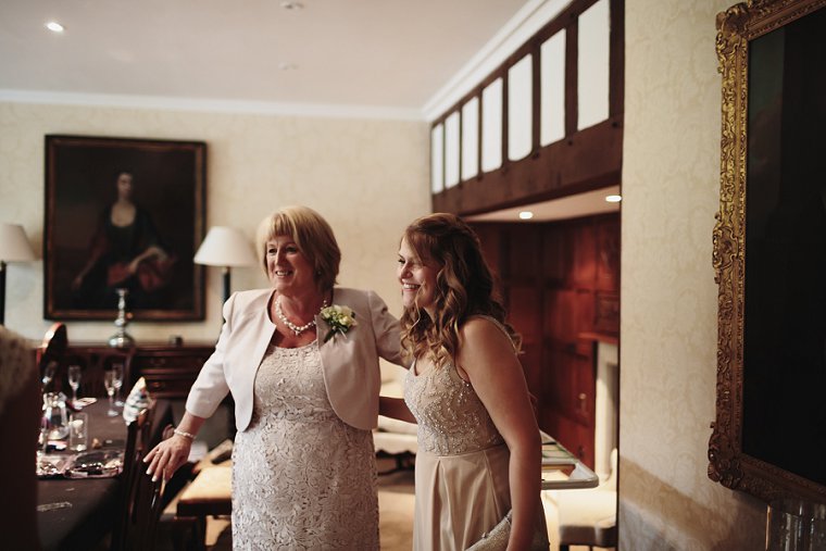 mother of bride hugging bridesmaid