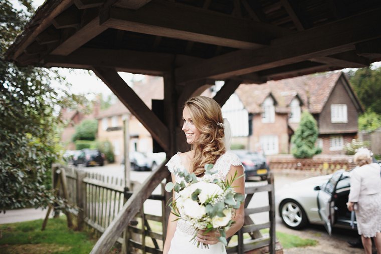 Bride smiling at entrance to church