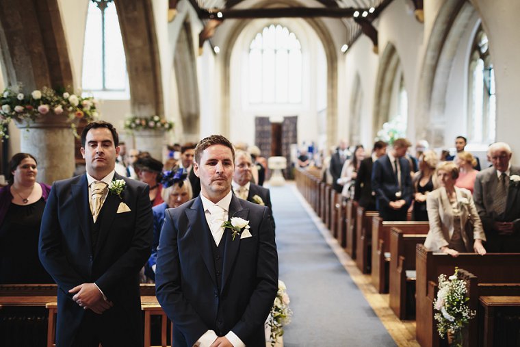 Groom waiting for bride at front of the church