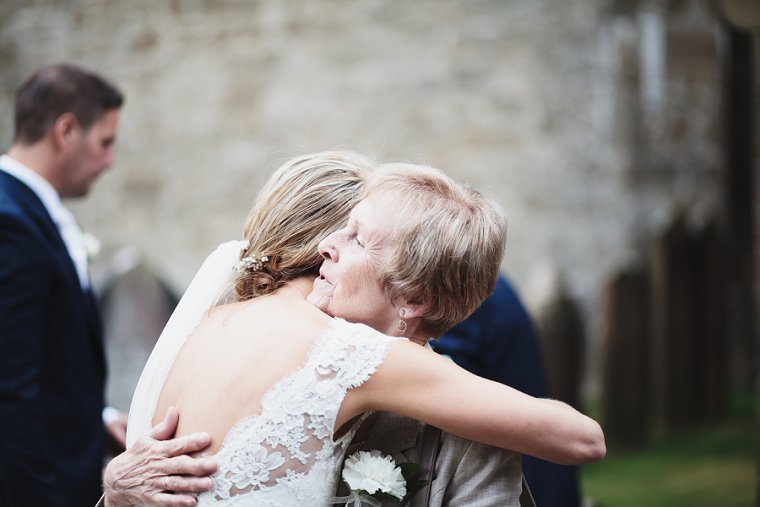 Bride hugging wedding guest