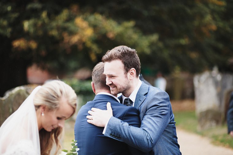 Groom hugging guest