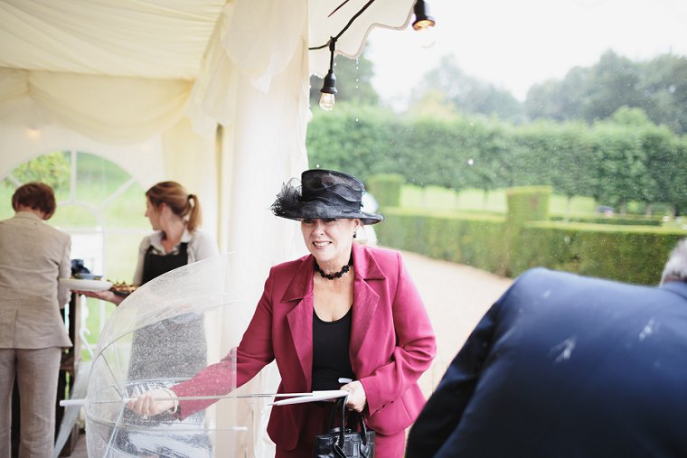 Rainy wedding day, guest underneath her umberella