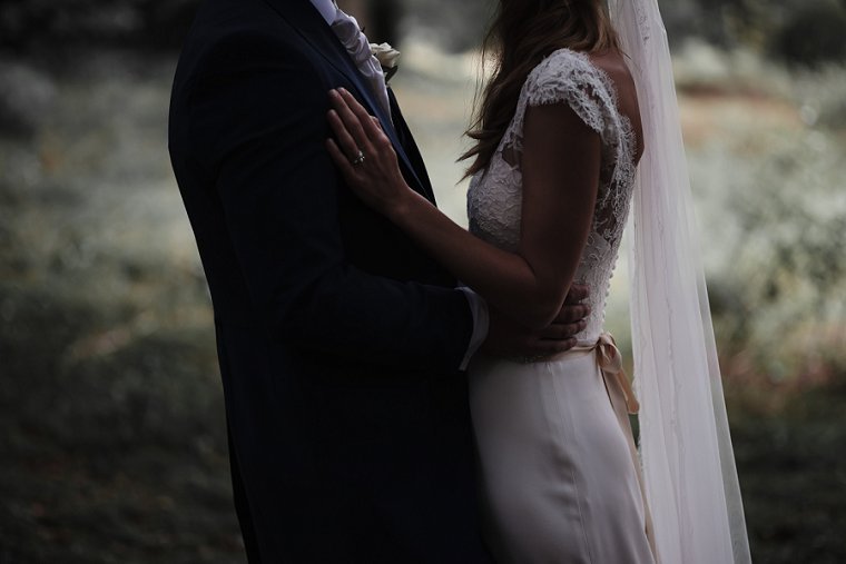 Bride resting hands on grooms chest