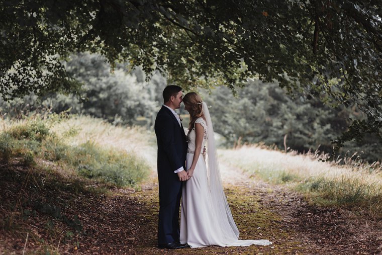 Groom kissing bride on the forehead at Squerryes Court Wedding venue
