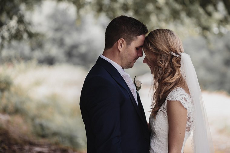Bride and Groom with eyes closed gently resting their foreheads together