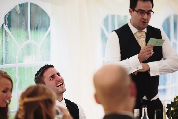 Groom laughing during his best mans speech