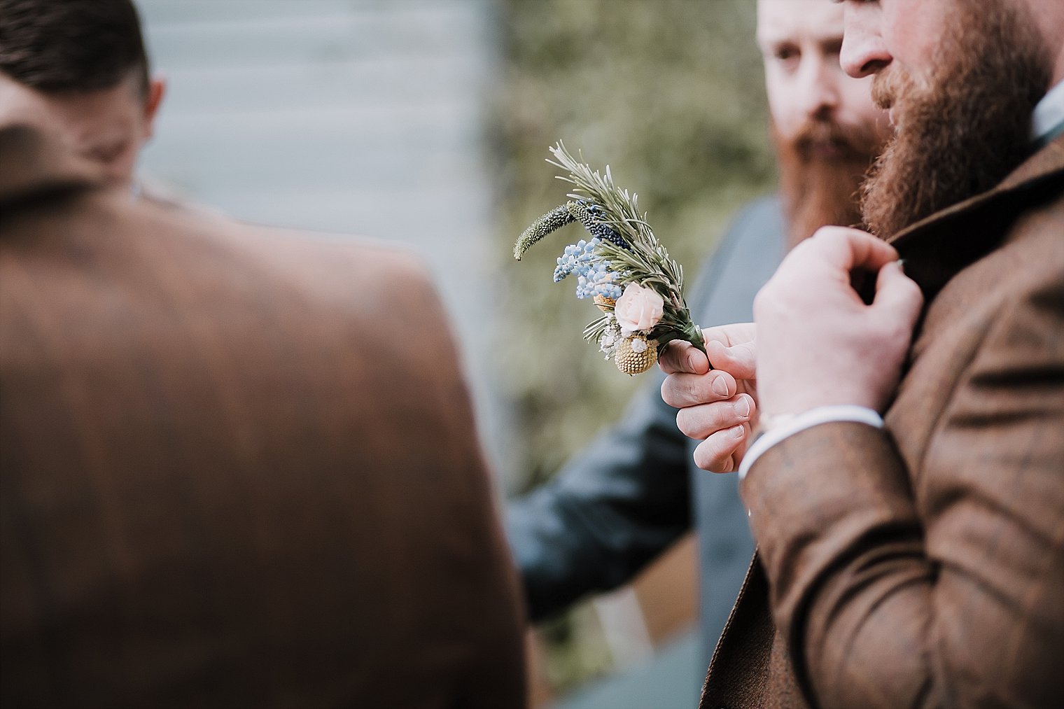 groom putting his button hole on supplied by Sweet William Florist Headcorn
