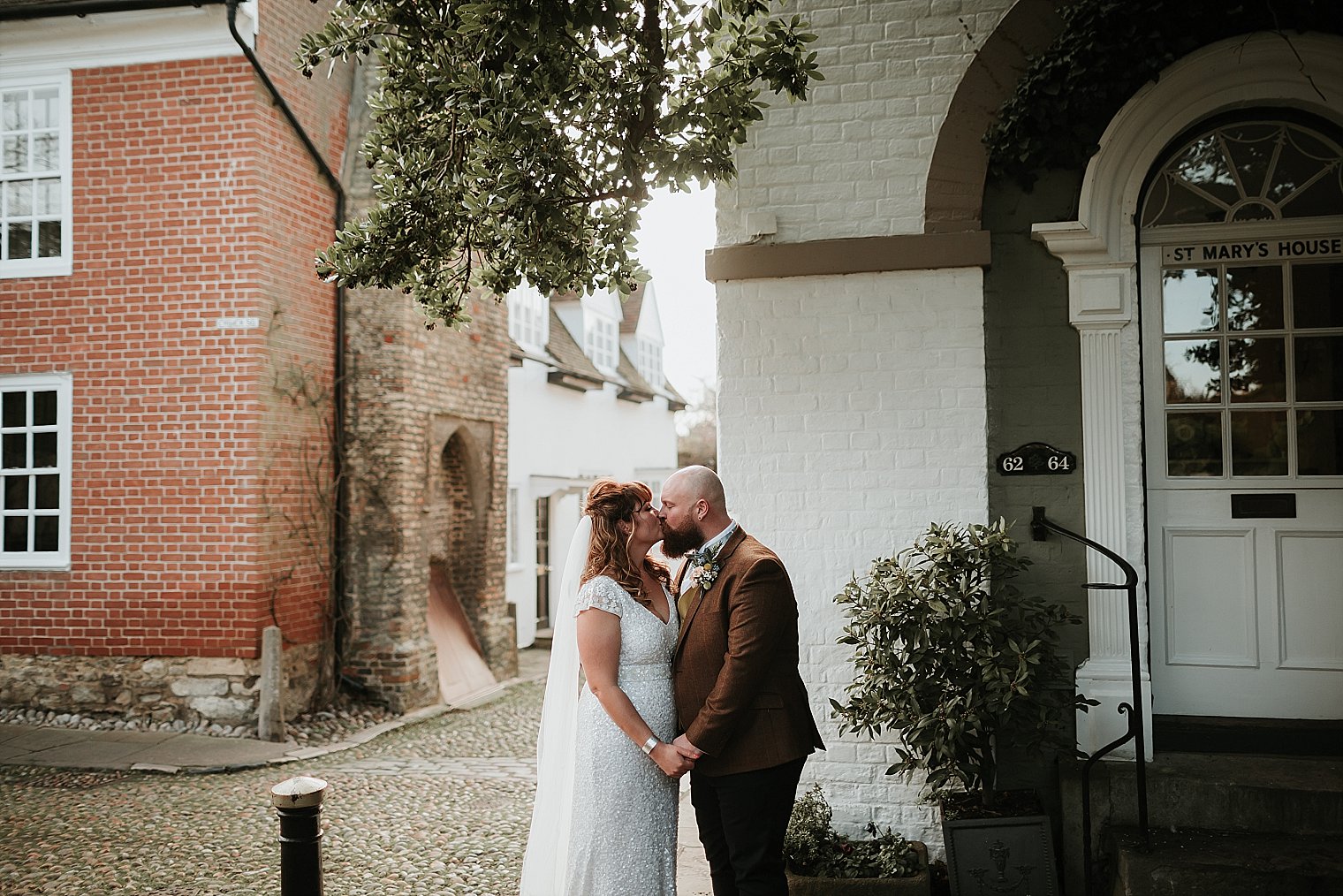Bride and groom kissing in Rye after their wedding at the george hotel