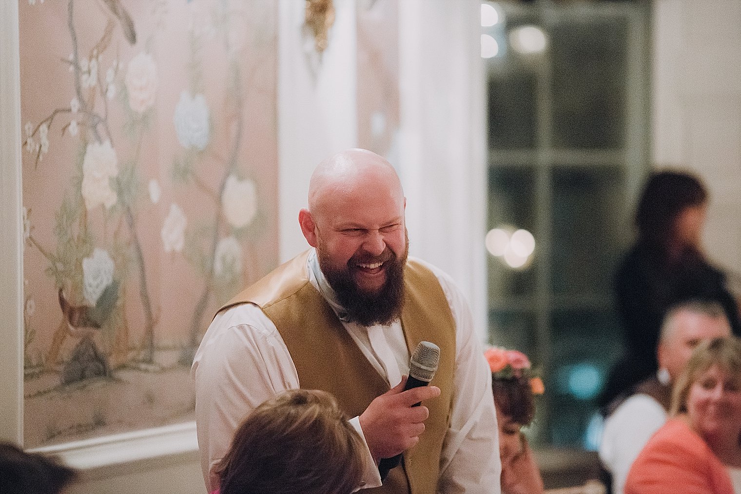 Groom laughing during the wedding speeches
