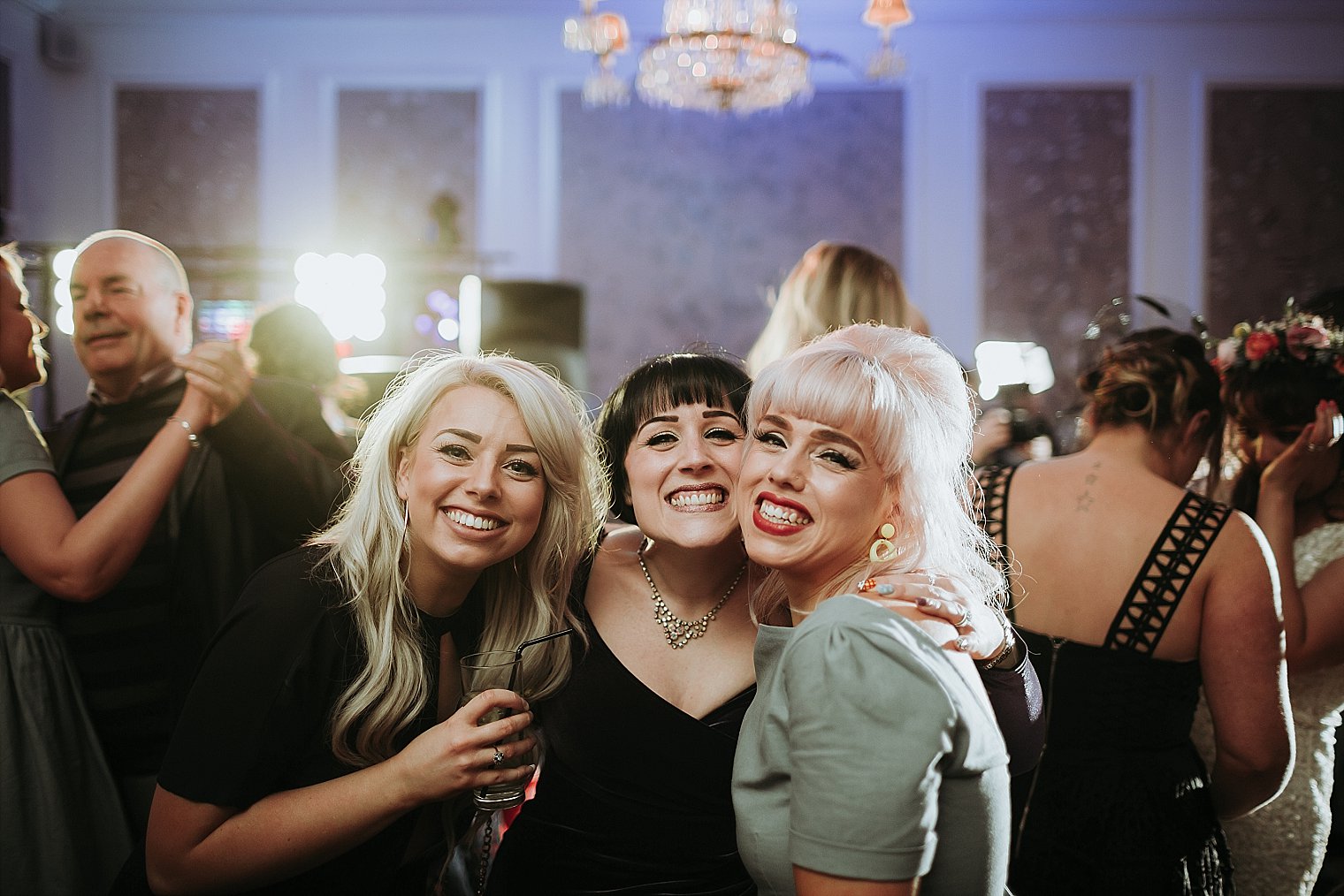 wedding guests smiling at the camera