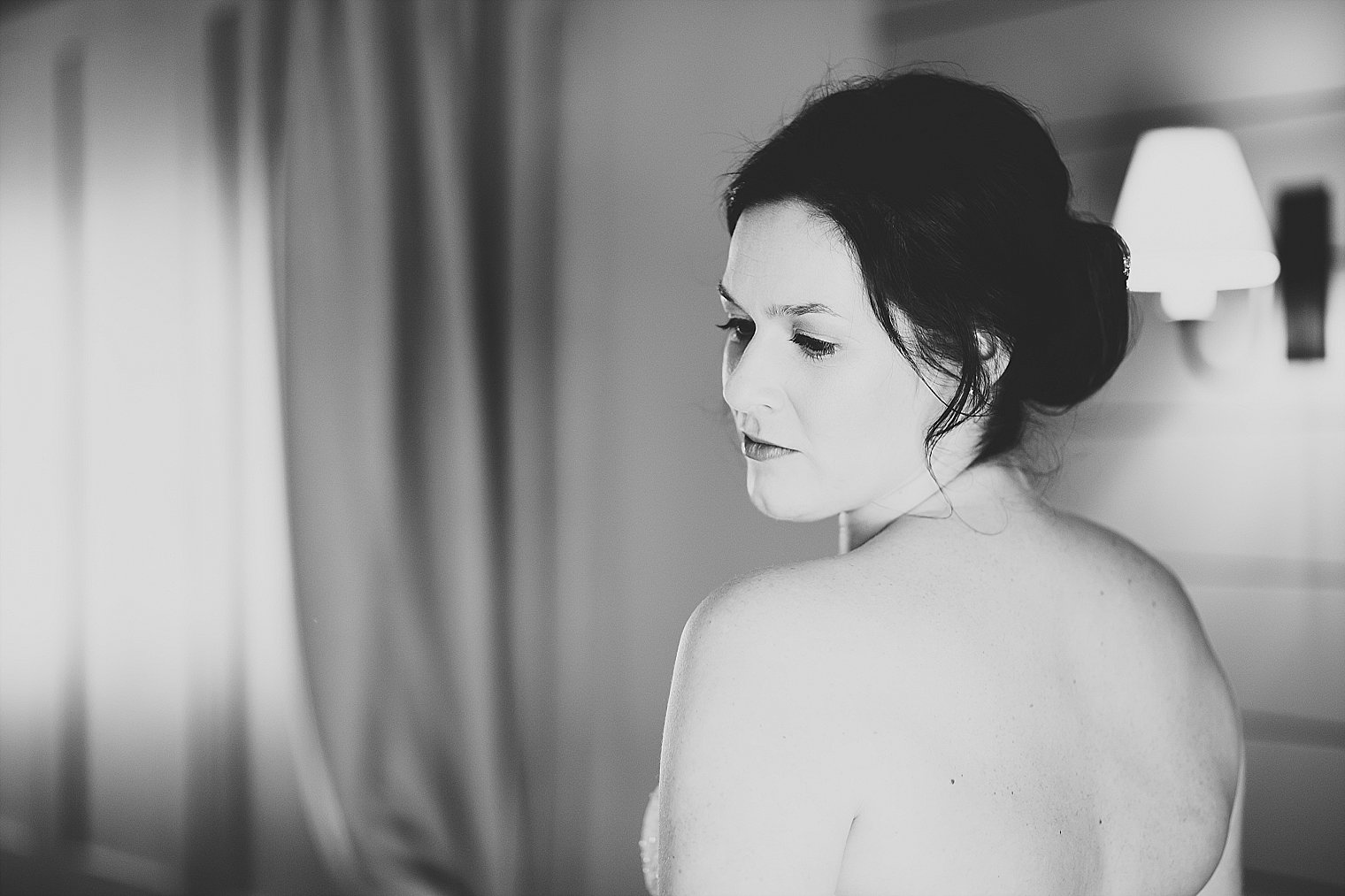Black and white photo of bride getting ready for her wedding