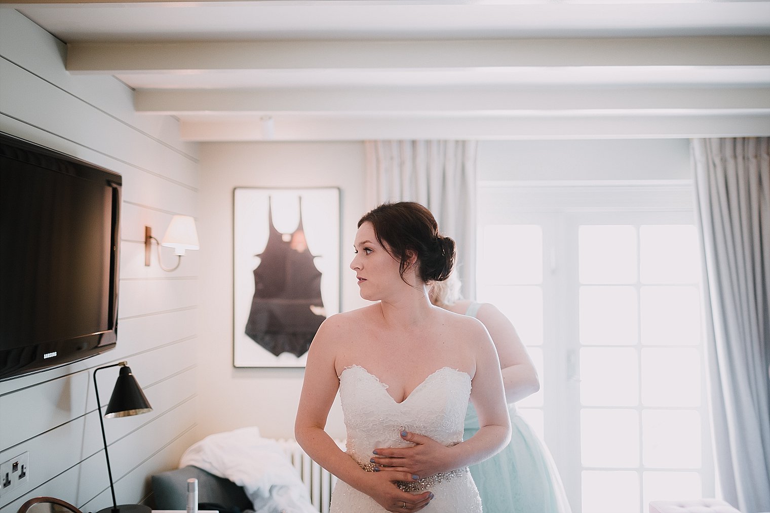 Bride looking in to mirror before her wedding