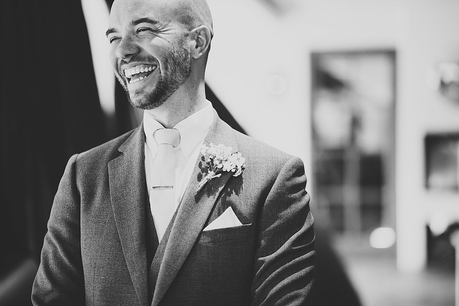 Groom laughing before wedding ceremony