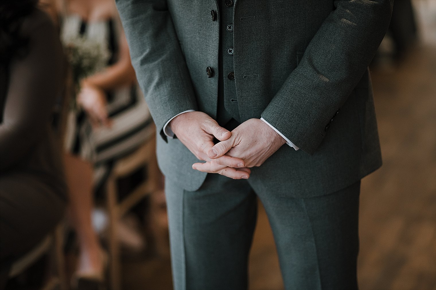 Close up of grooms hands