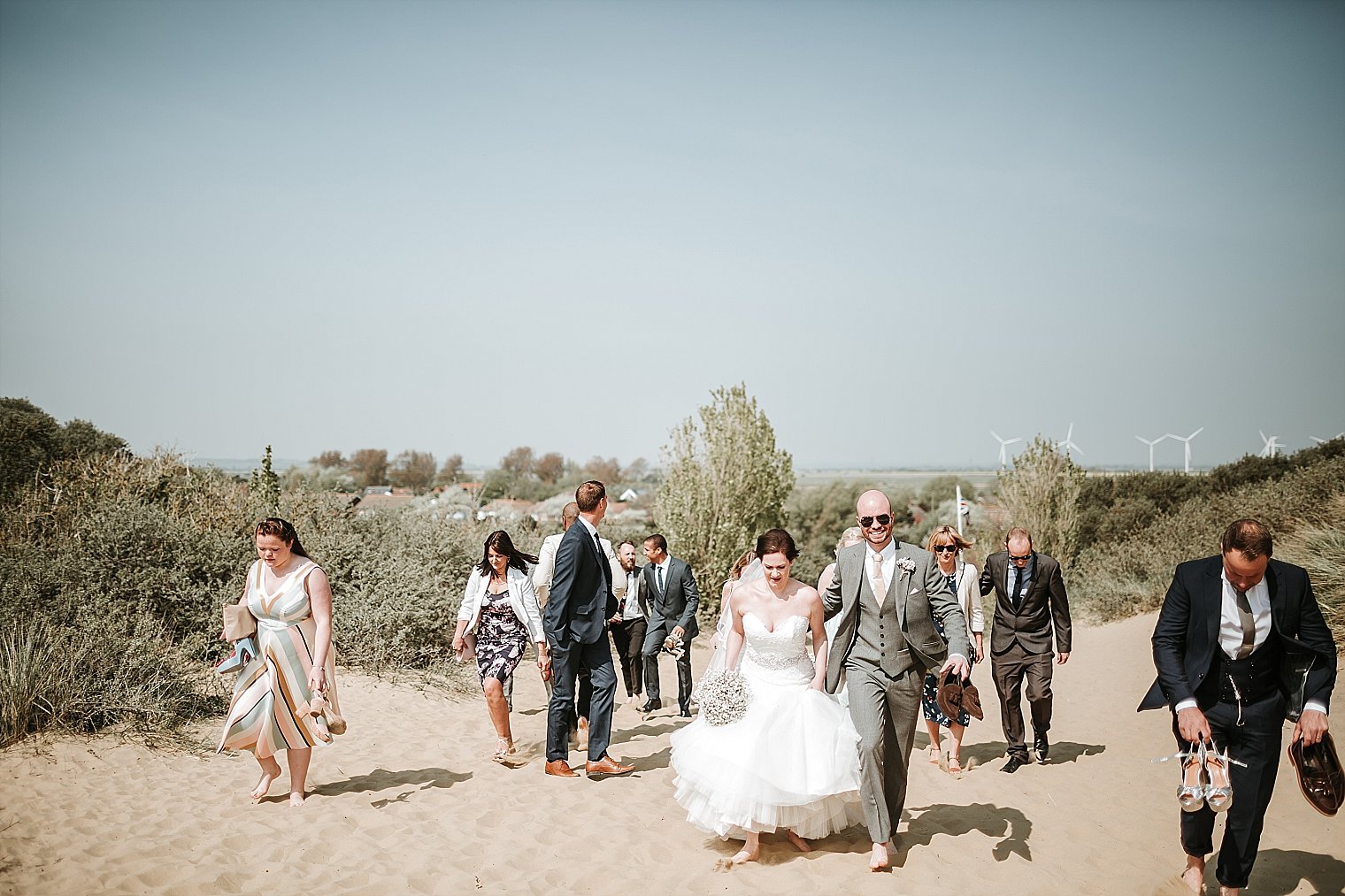 Bride and Groom walking on Camber Sands