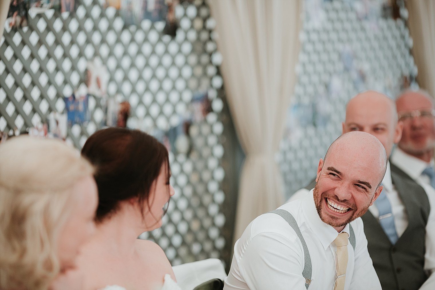 Groom lauhging during the father of the brides speech