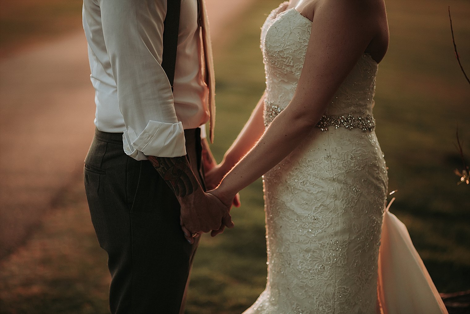 Bride and Groom holding hands at sunset