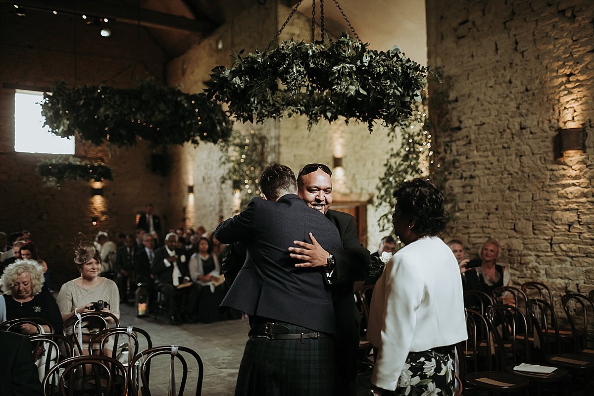 Groom hugging family member