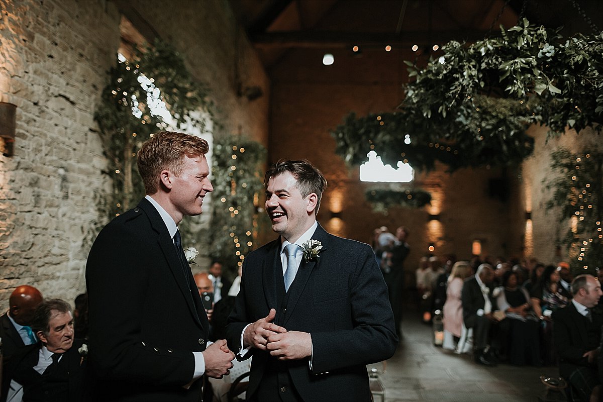 groom laughing with his best man