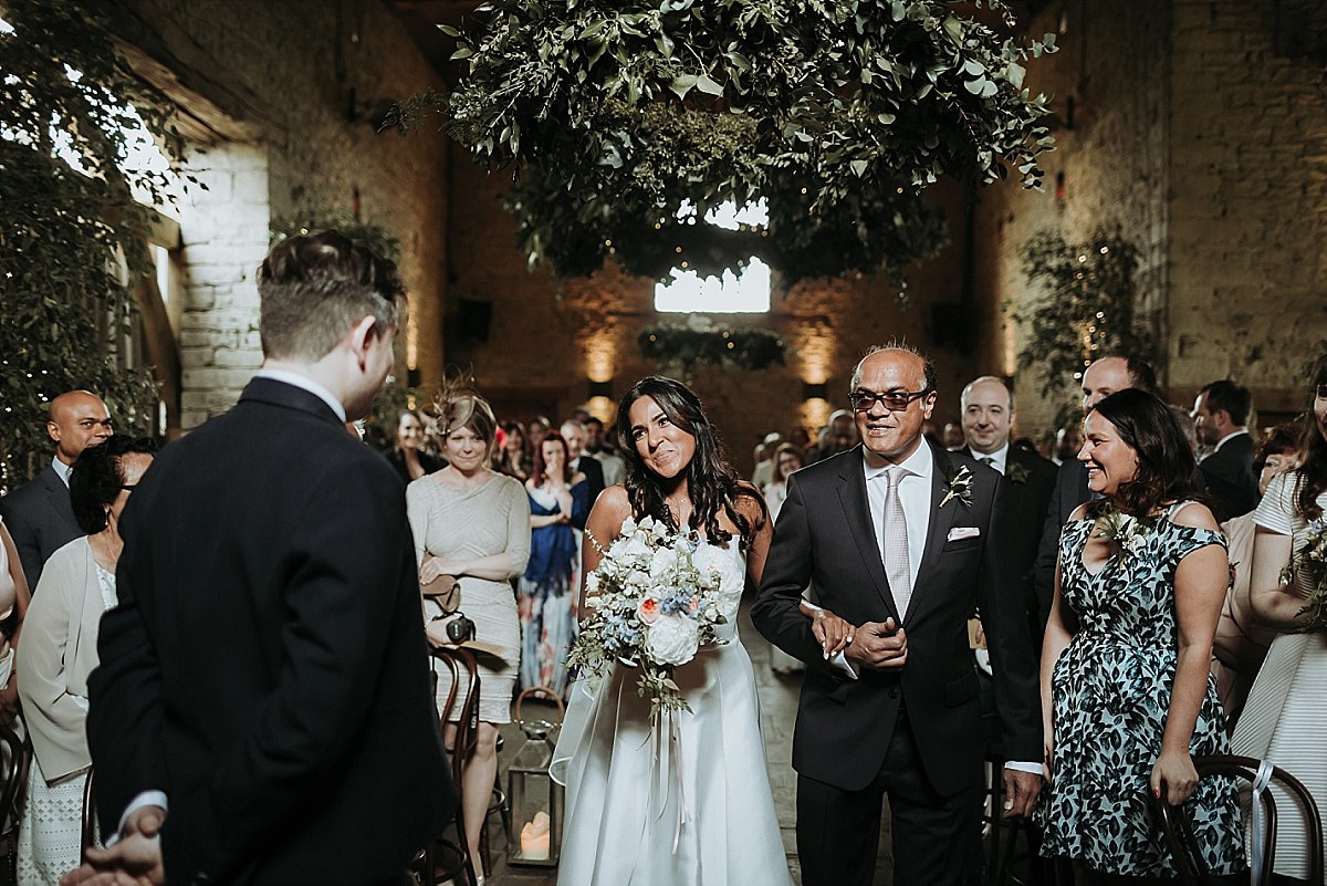 Bride walking down the aisle at Cripps Barn
