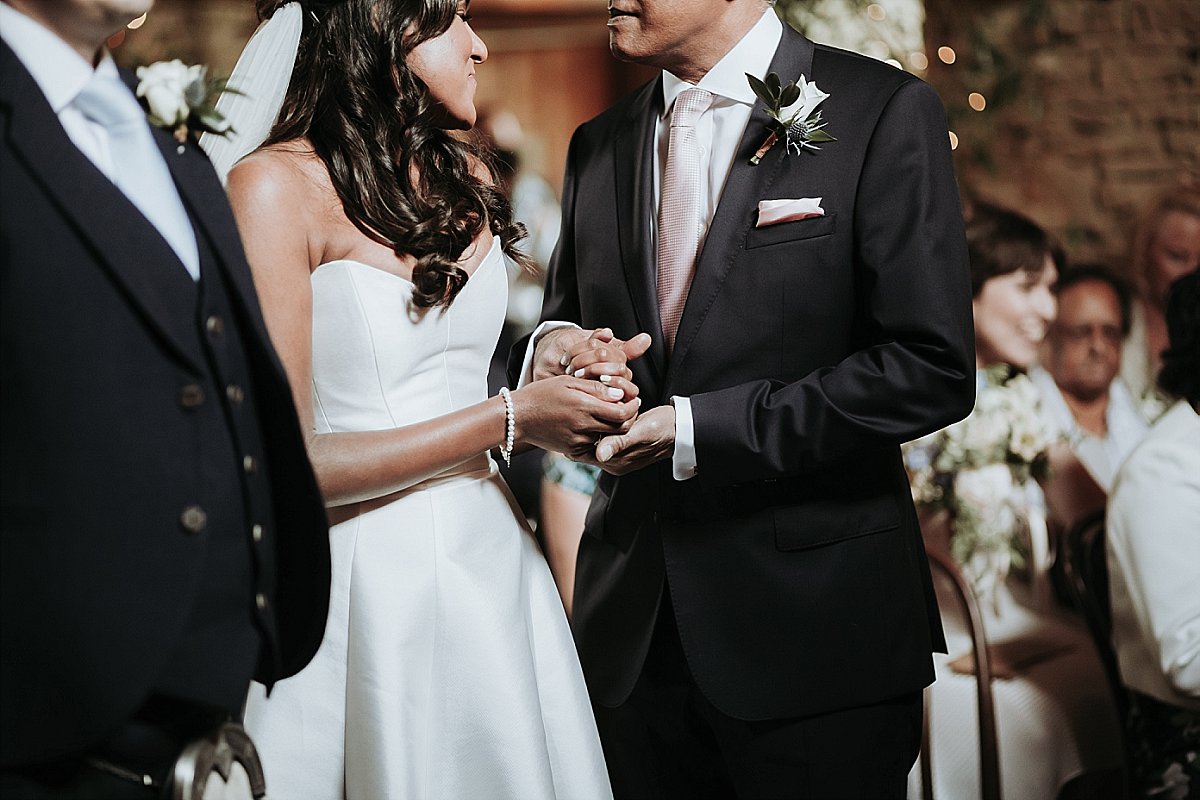 Bride holding her fathers hand