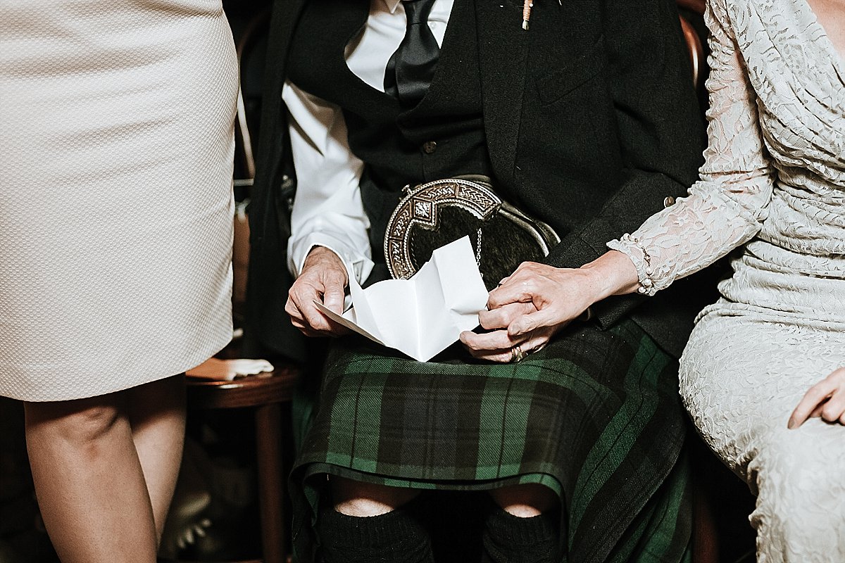 Mother of the groom holding father of the grooms hand