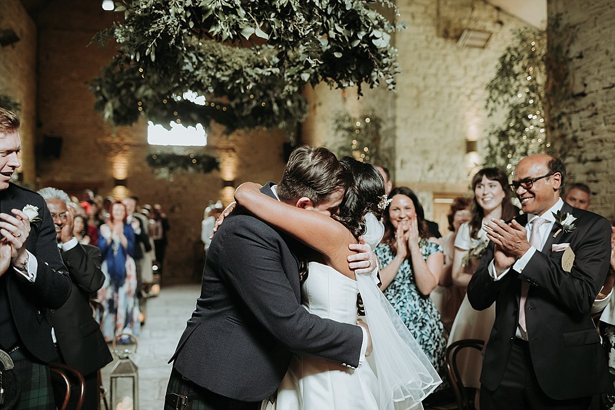 Bride hugging groom after wedding ceremony