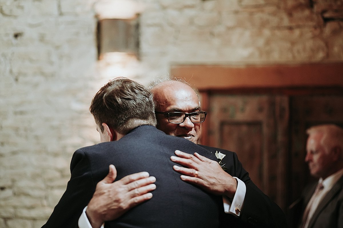 Father of the bride hugging the groom