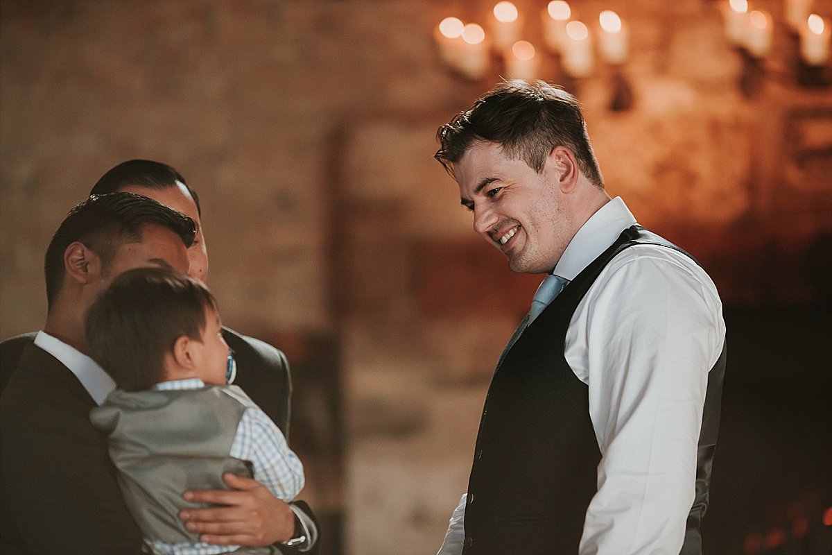 Groom laughing with guests