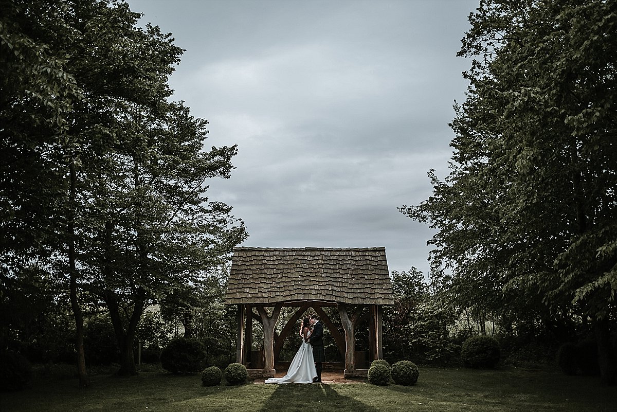 Bride and Groom posing for natural wedding portrait at Cripps Barn