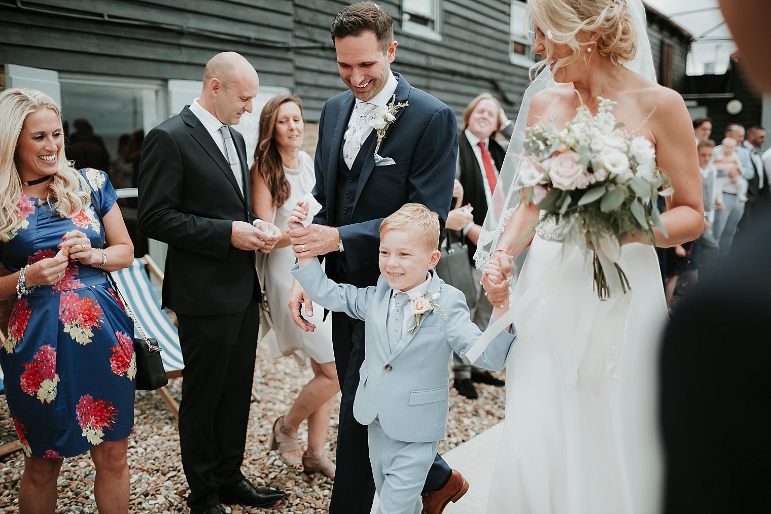 Bride and Groom with their son walking through confetti at Whitstable Brewery Bar