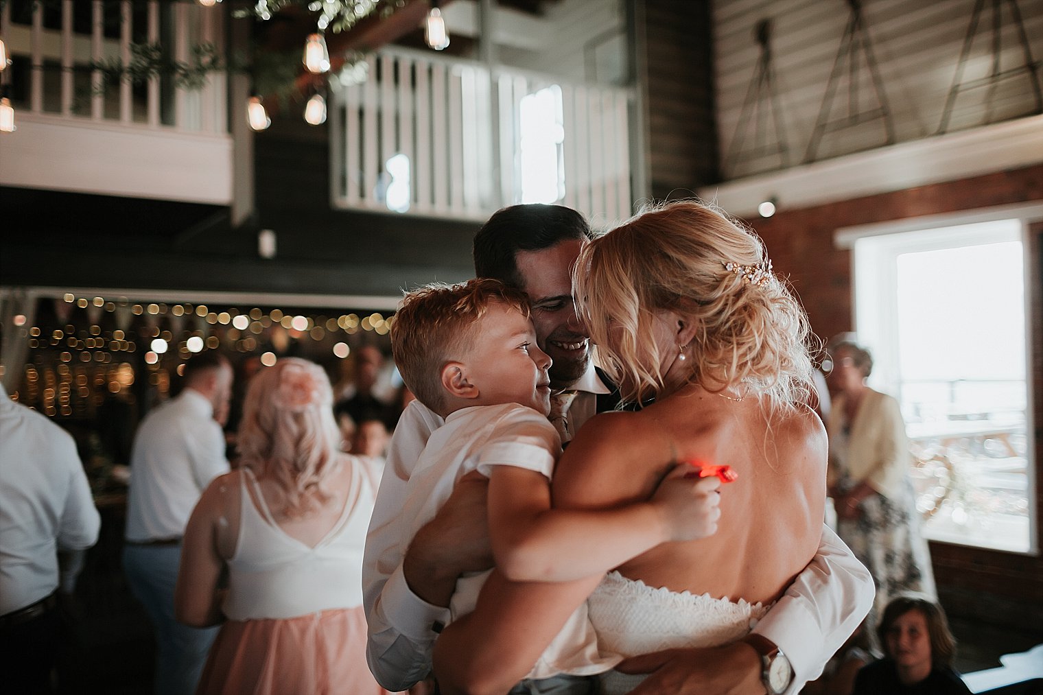 Bride and Groom holding their son during first dance at The Lobster Shack