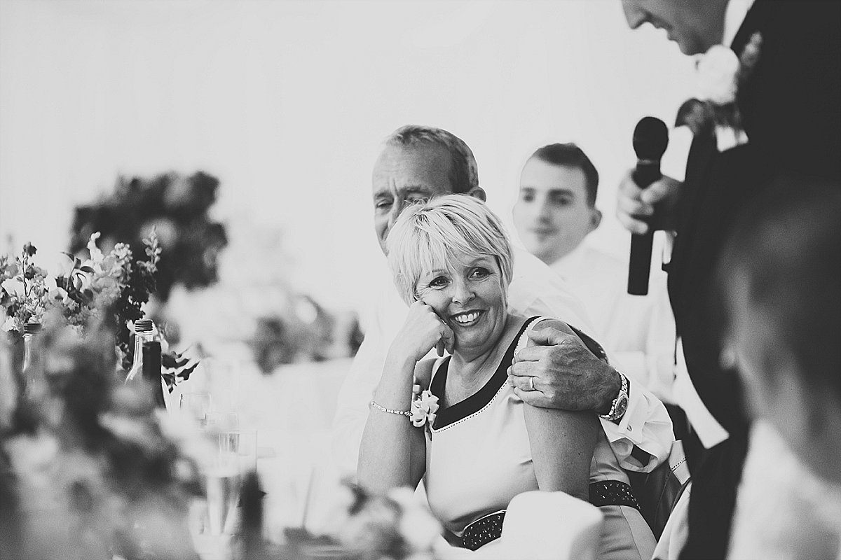 Mother of the groom smiling during her sons wedding speech