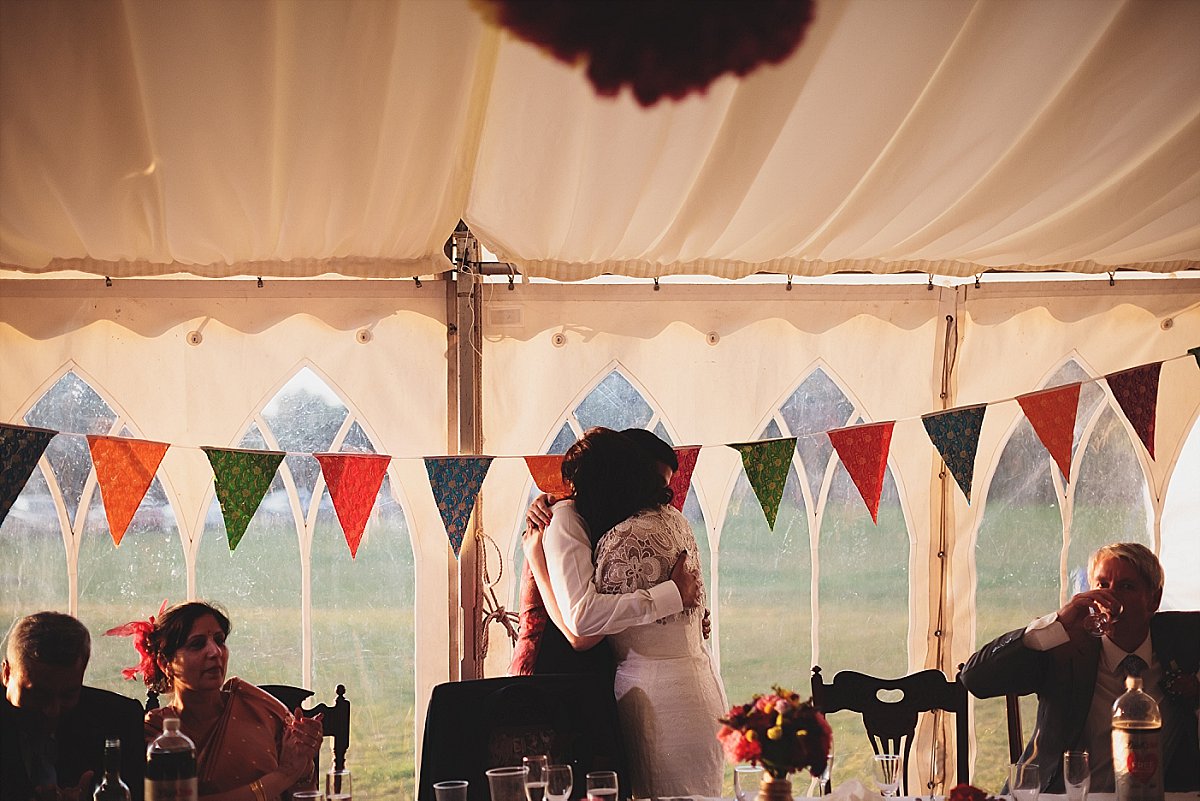 bride and groom hugging after the groom has given his wedding speech