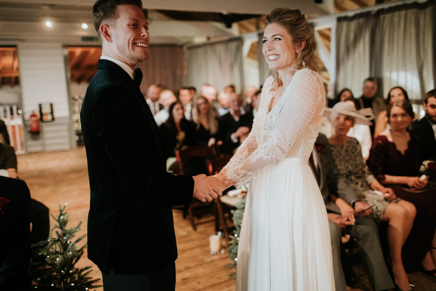 Bride and Groom holding hands and smiling at eachother