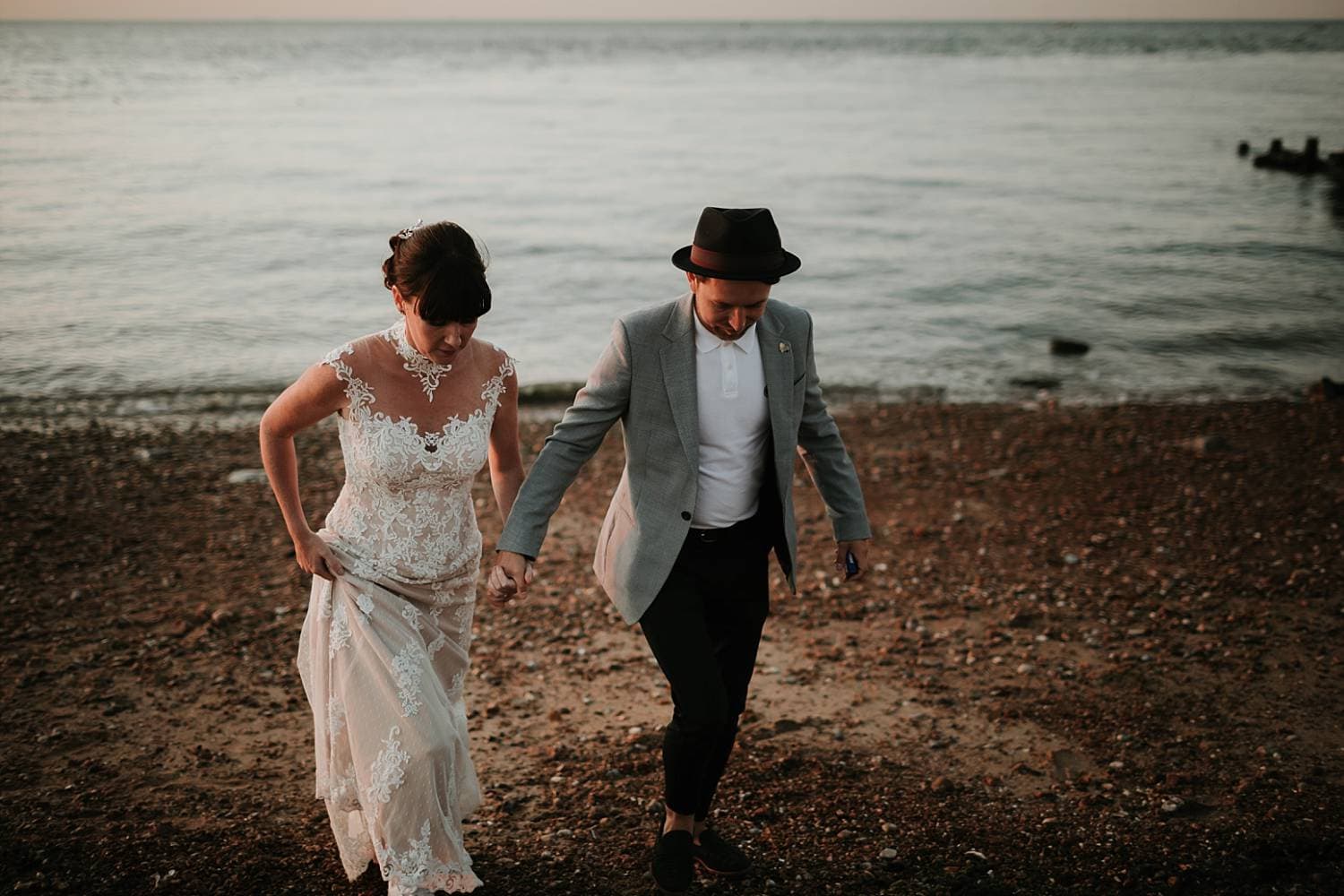 Wedding couple walking along the beach